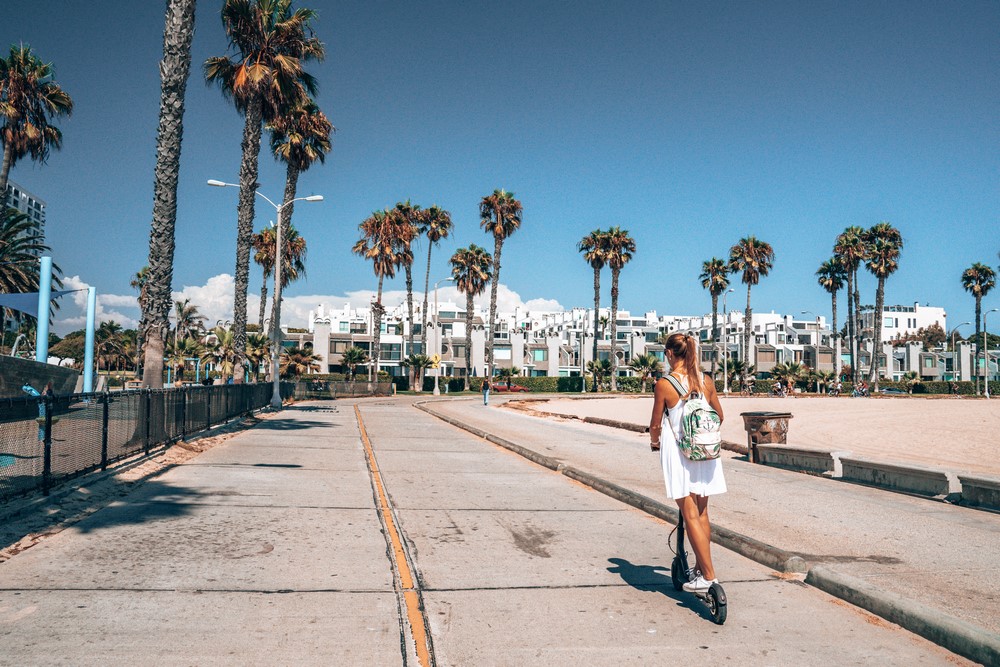 Beautiful,Girl,Riding,An,Electric,Scooter,Down,The,Venice,Beach